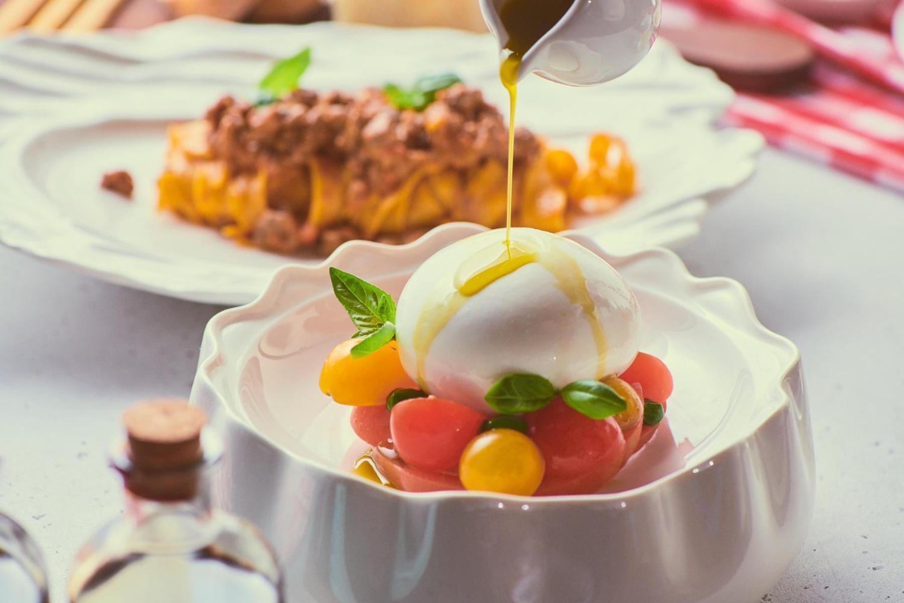 Five Jumeirah Village Dubai Esterno foto A salad being drizzled with olive oil